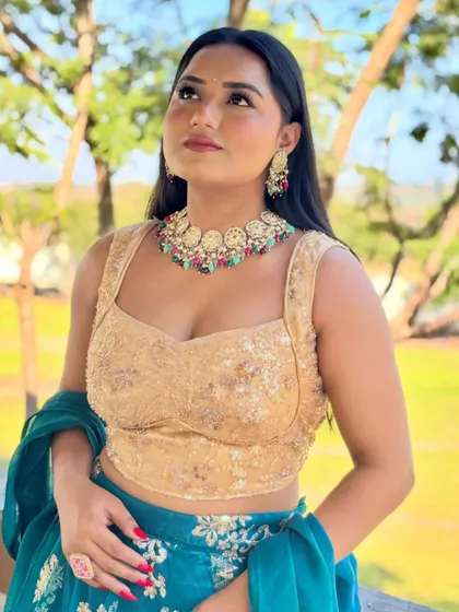 Looking up with a smile, feeling the festive energy. This outfit is ideal for an outdoor wedding carnival or Mehendi ceremony, combining traditional embroidery with a modern silhouette.