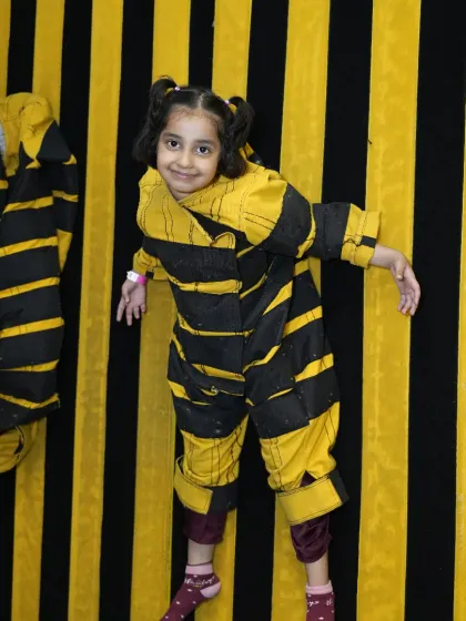 A guest has a laugh while trying out our velcro "bee" suit. This interactive attraction is a memorable part of the Tingaland experience and makes for great photos.