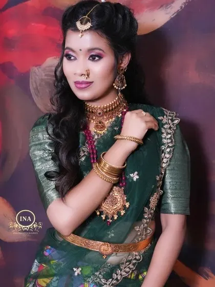 A side profile showcasing the elegant drape of the dupatta and the detailed blouse of the green half saree.