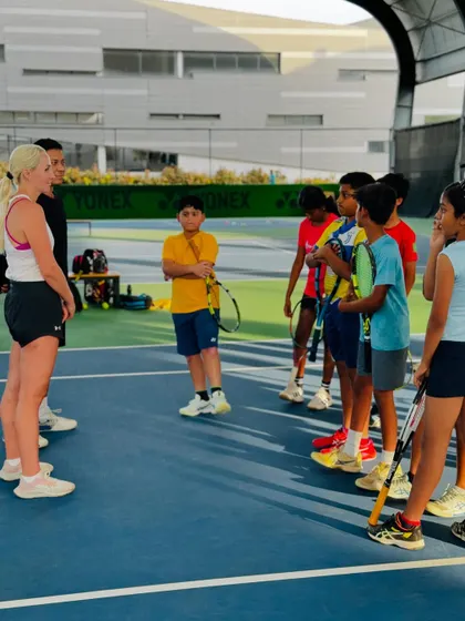 Diana and our coach lead a group discussion on the court, answering questions from our junior players about life on the professional tour.