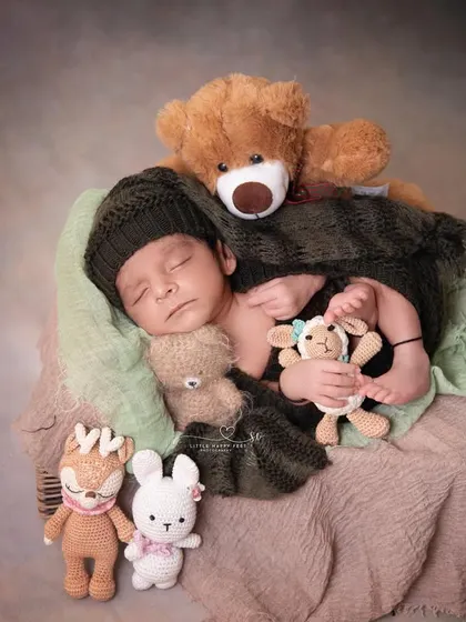 Surrounded by his entire collection of stuffed animals, this little boy is clearly so loved. It's a sweet way to incorporate a child's favorite toys into their first photoshoot.