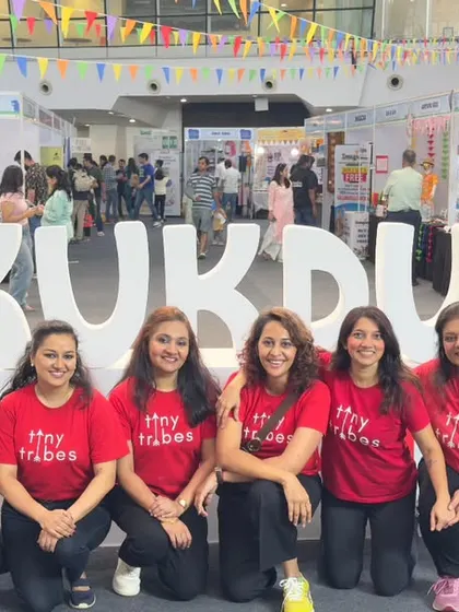 The Tiny Tribes team posing in front of the Kukdukoo sign. Participating in India's biggest children's festival is a testament to the quality and appeal of our play based programs.