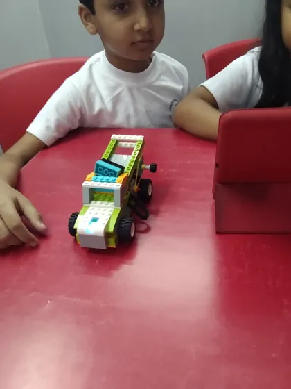 A close-up of a student's first robotic vehicle, built with the LEGO WeDo kit, a foundational tool in our curriculum.