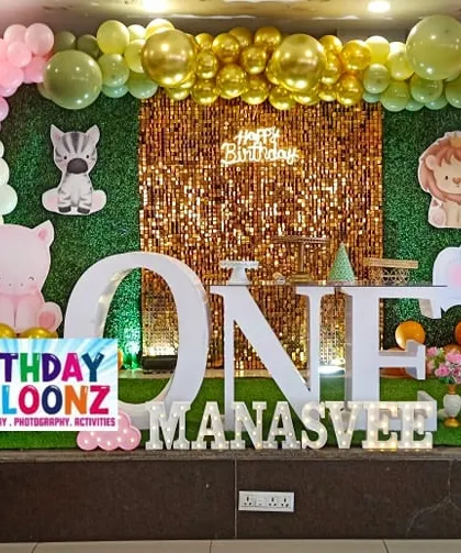 I designed this gentle jungle theme with a mix of soft pink and green balloons. The setup includes a gold sequin backdrop, cute animal cutouts, a picket fence, and a large "ONE" table, creating a sweet and inviting look for a first birthday.