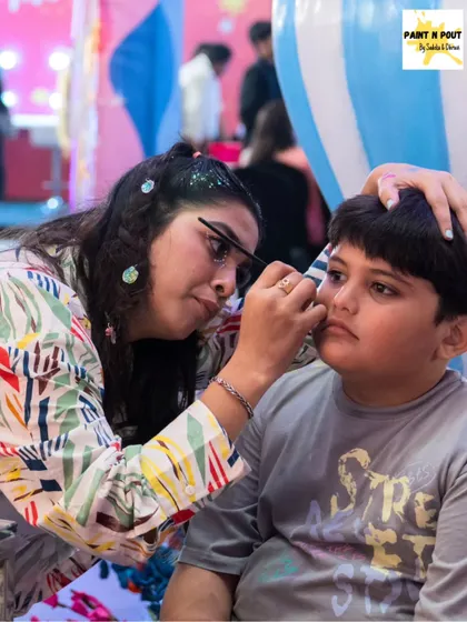 A young boy getting his face painted. We have plenty of awesome designs for boys, from superheroes to cool abstract patterns.
