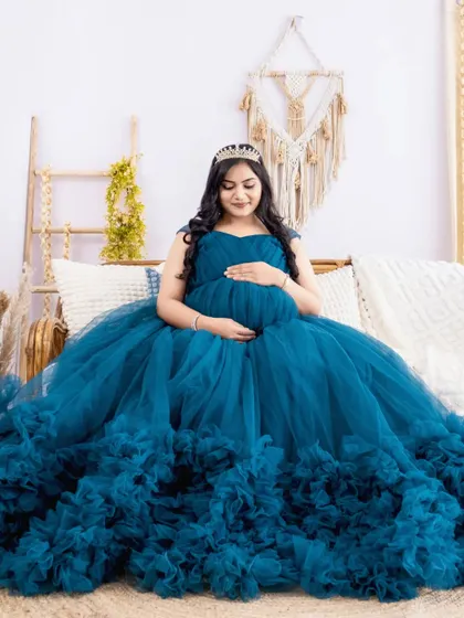 A fairytale moment for this mom-to-be, seated in a magnificent blue ruffled gown and wearing a crown. We love making our clients feel like royalty.