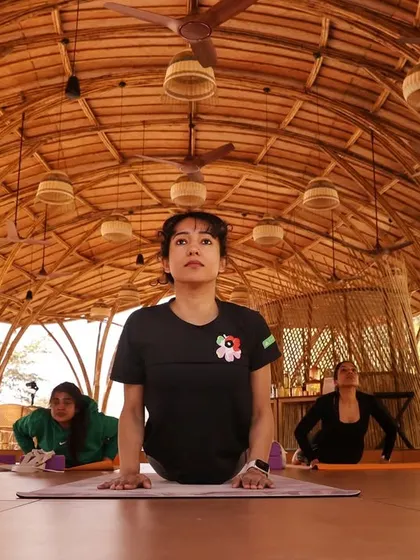 A student embodying strength and focus in Bhujangasana, or cobra pose. Our retreat practices are designed to build physical and mental resilience, allowing you to explore your limits in a supportive environment.