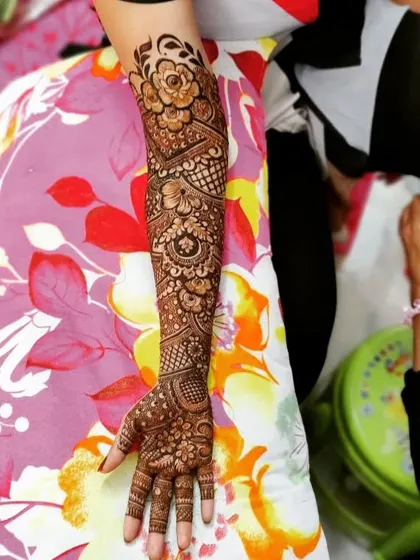 A single arm view of a full bridal design for Shagufta. The floral and geometric patterns create a beautiful and intricate look.
