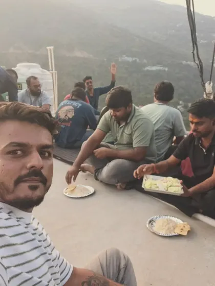 Enjoying a simple meal with the group on a rooftop with a mountain view. Sometimes, the best moments are the simplest ones.