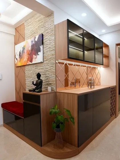 This entryway for Palak and Ashwani is designed for both beauty and function, with a built-in bench, a serene Buddha statue, and an elegant bar and crockery unit.