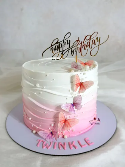 Beauty in simplicity. An elegant ombre pink buttercream cake adorned with delicate wafer paper butterflies.