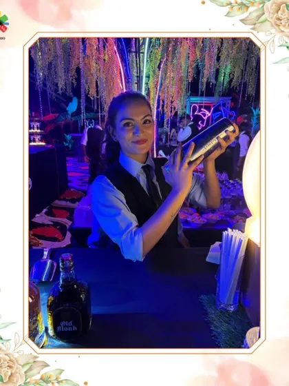 Our star mixologist, Aisha, confidently shakes a cocktail. This image celebrates the skill and presence of our talented female bartenders who break stereotypes and deliver exceptional service.