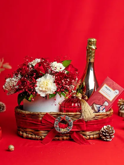 A luxurious Christmas hamper featuring a non-alcoholic champagne, fresh flowers, and festive decor. It's the perfect way to send holiday cheer to clients or loved ones.