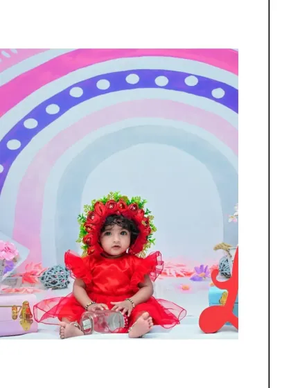 A quiet moment captured during the rainbow-themed session. The baby's calm expression contrasts beautifully with the bright and colorful setting.