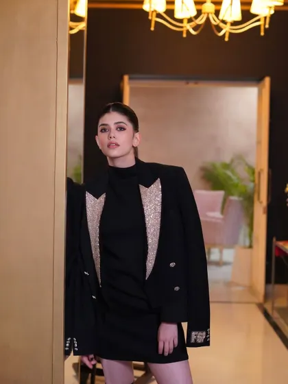 A full-length shot showing how a simple, well-executed ponytail can be the perfect finishing touch to a glamorous look.