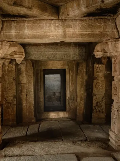 The interior of a temple, focusing on the carved pillars and the dark, mysterious doorway. I use light and shadow to create a sense of atmosphere.