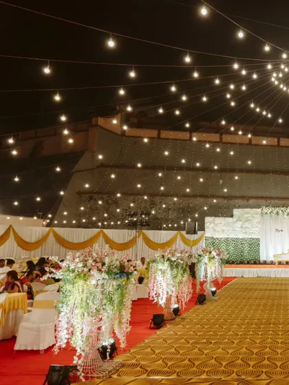 Another angle of the reception setup, showcasing the beautiful cascading floral arrangements that lined the main aisle, and the canopy of lights that created a magical ceiling.