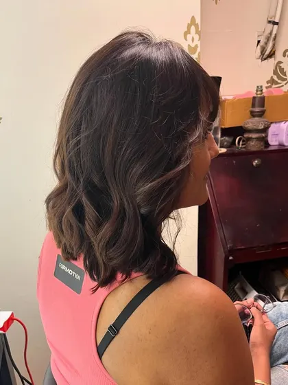 A brown balayage and a wispy bob with bangs for Shivani.