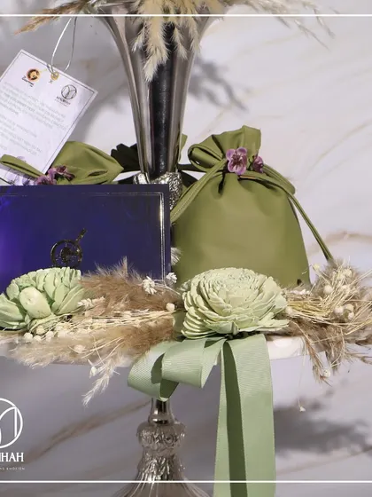Another angle of The Gourmet Fest invitation, highlighting the olive green potli and the personalized tag, creating a complete and luxurious welcome package.