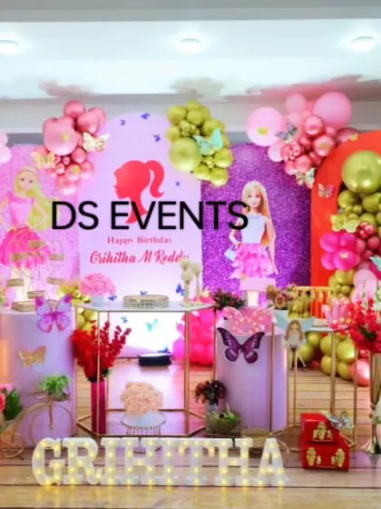 A glamorous Barbie-themed birthday party for a 3-year-old. This elaborate setup includes multiple backdrops, character cutouts, a large balloon arrangement in pinks and purples, and marquee letters for the birthday girl's name.