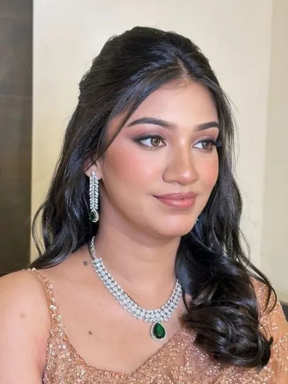 A client's reception look, featuring soft, open waves that pair beautifully with her diamond jewelry.