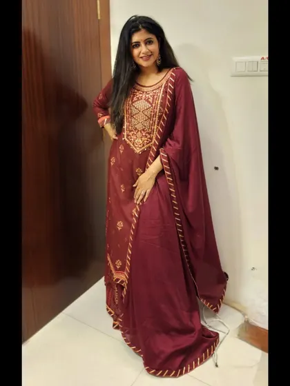 A full-length shot in the deep maroon suit, perfect for a corporate event or a formal celebration.