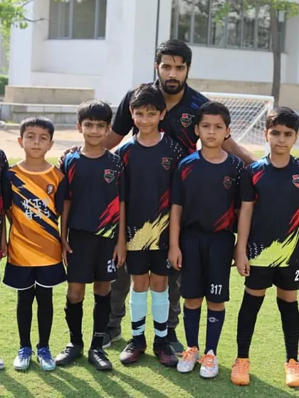A team photo with their coach, united and ready for the game.