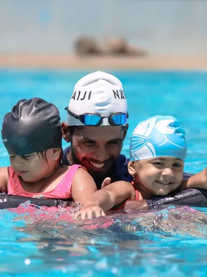 A coach can make all the difference. Here, one of our instructors supports two toddlers at once, ensuring they both feel safe and have fun while learning.