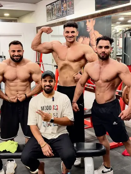 Working hard with my athletes. We are coming to dominate. A group posing session at the gym.