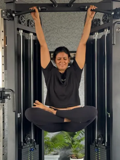 Sometimes you just have to monkey around. I love incorporating Padmasana into unexpected places, like hanging from a pull-up bar. It's a playful way to challenge my core and hip flexibility.