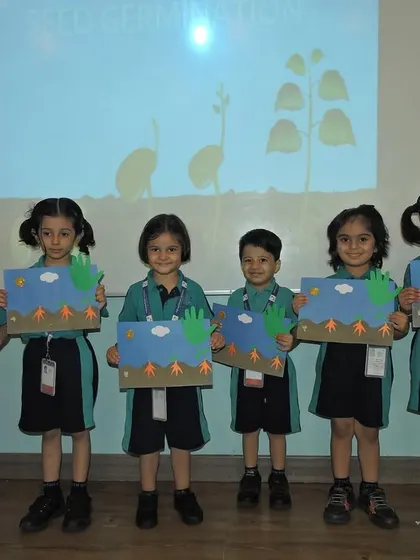 Students display their craft projects illustrating the process of seed germination, a creative way to learn about plant life cycles.