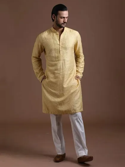 A textured yellow kurta with a detailed placket. This outfit combines subtle texture with a classic design for a refined and comfortable ethnic look.