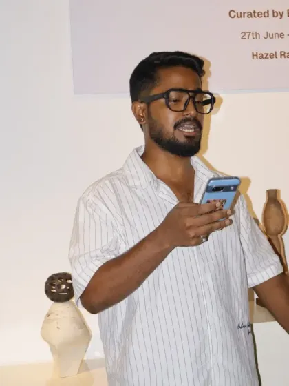 An artist shares his perspective during the showcase. These events provide a crucial platform for artists to practice public speaking and articulate the concepts behind their work to an engaged audience.