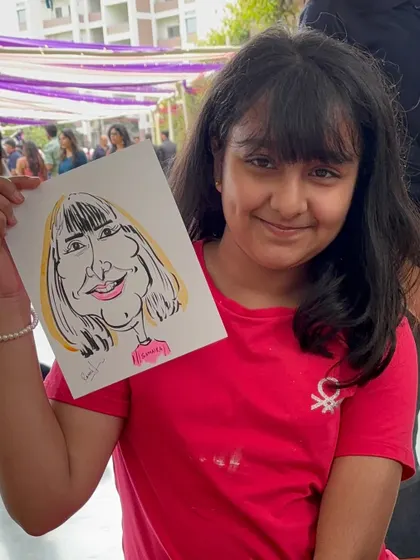 Another happy young guest at the alumni meet, showing off her new portrait.
