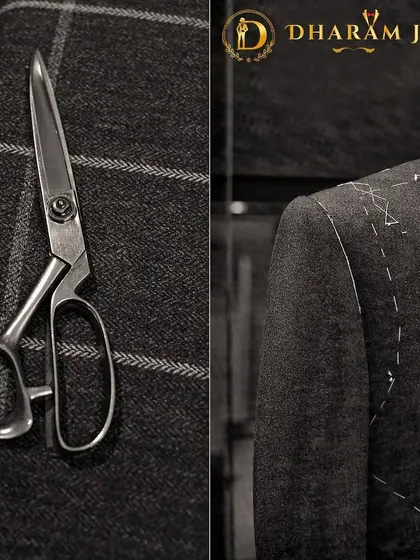 A glimpse into the tailoring process. The tailor's scissors and the half-finished jacket with visible basting stitches show the hands-on work that goes into every bespoke suit.