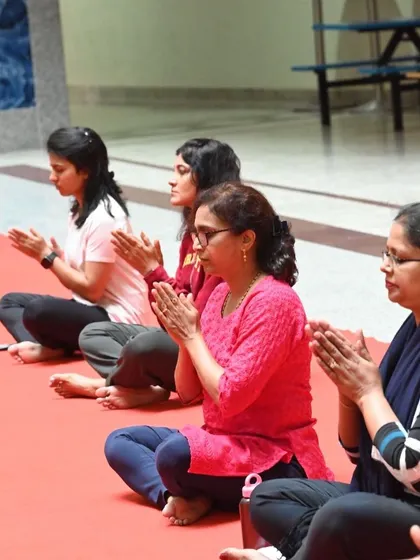 A closer look at participants during a guided meditation or pranayama exercise in a group class. The collective focus creates a powerful, calming atmosphere.