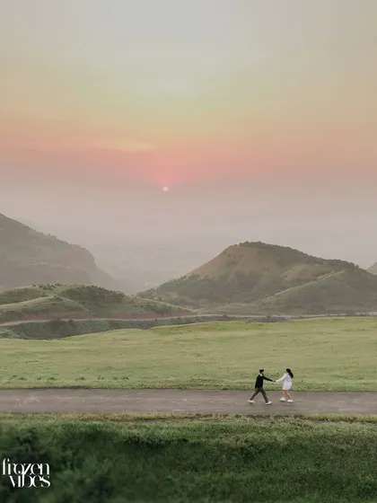 Monil and Charmi walking into the sunset. I often use wide shots like this to create a sense of journey and adventure, placing your love story within a vast, beautiful world.