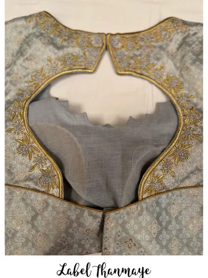 A close-up of the embroidery work on the grey blouse.