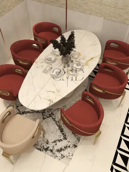 An aerial view of the dining set, emphasizing the unique shape of the marble table and the bold geometric pattern of the flooring inlay.