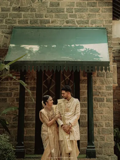 A moment of quiet connection. The couple stands together, their traditional outfits and serene expressions creating a portrait of timeless grace.