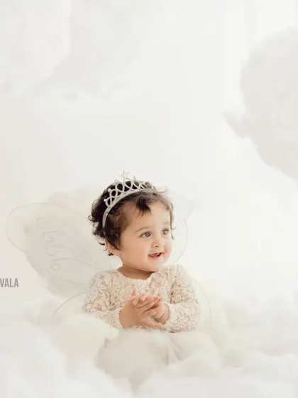 An angel in the clouds. This simple, elegant portrait with fairy wings and a crown is perfect for capturing the magical innocence of childhood.