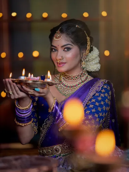 Holding the light. This portrait captures the warmth and happiness of the festival, reflected in her glowing makeup.