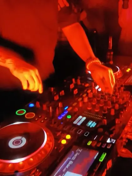 A close-up of my hands on the mixer during a Bolly-Tech set. This genre requires precise control to blend the different elements of Bollywood and techno seamlessly.