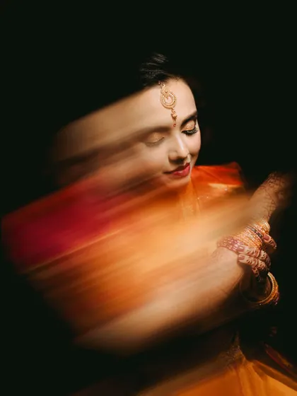 The color version of my motion blur portrait technique. The warm tones of the bride's saree streak across the frame, creating a vibrant and dynamic piece of art that captures her energy.