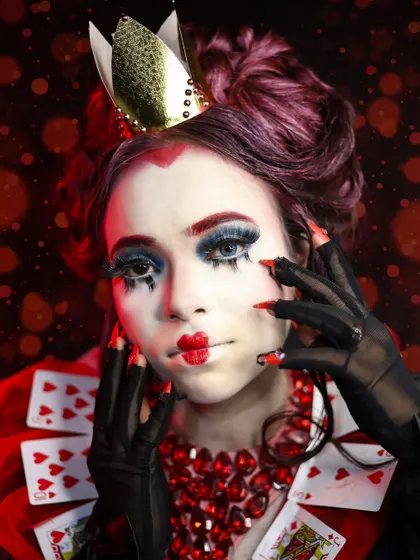A portrait of the Queen of Hearts with a bokeh background, adding a magical touch to the image.