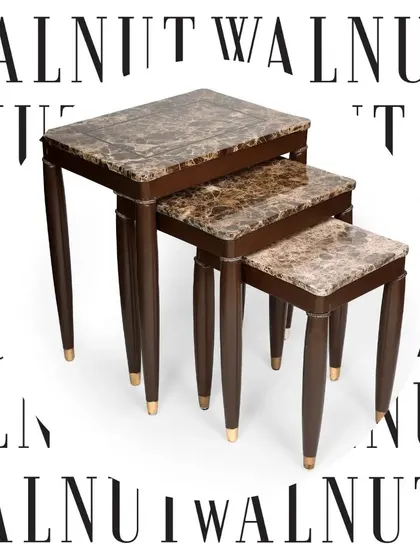 A full view of the elegant nest of tables with marble tops and brass-tipped legs. This classic design is perfect for adding a touch of refined luxury to a living room.