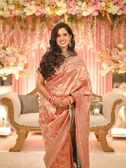 A quick change for the reception, from a traditional Marathi bride to a modern glam look. This shows how we can create multiple distinct styles for your different wedding events, complete with soft curls and elegant makeup.