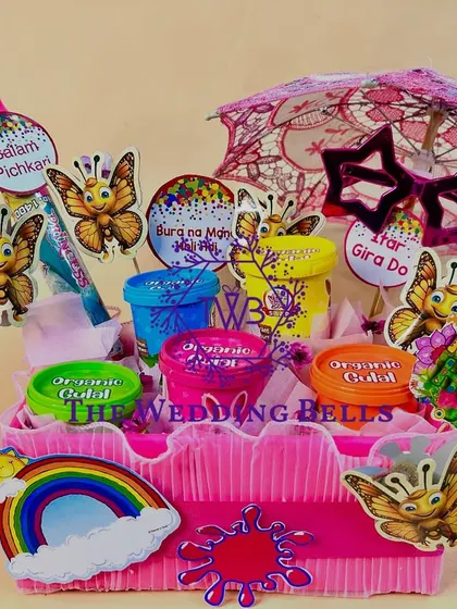 The complete "Summer's Here" Holi hamper, with a pichkari, a mini umbrella, and other festive accessories.