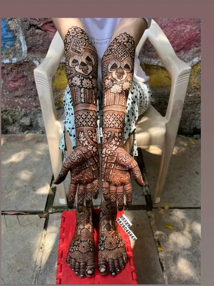 Here is a complete bridal mehndi look, with detailed, symmetrical designs covering the arms, hands, feet, and legs. I ensure the patterns flow beautifully for a stunning result from every angle, making you feel like a queen on your special day.