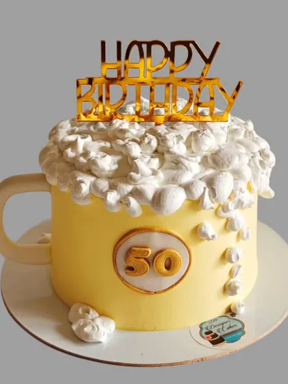 A fun beer mug cake for a 50th birthday. The whipped cream foam on top makes it look just like a frothy mug of beer.